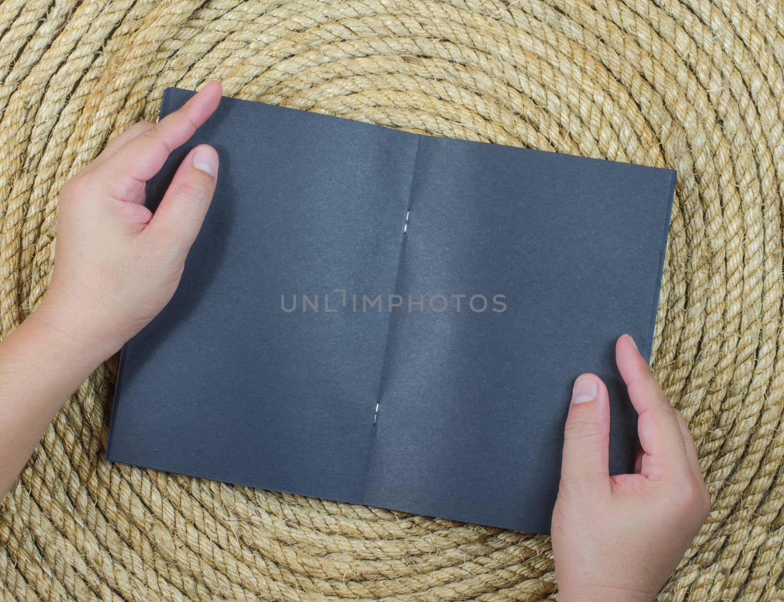 Open Hand Book on a jute rope background