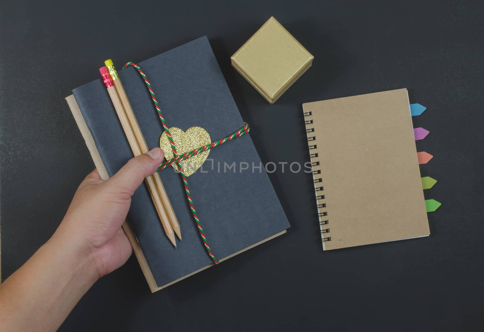 write paper notebook pencils on black background