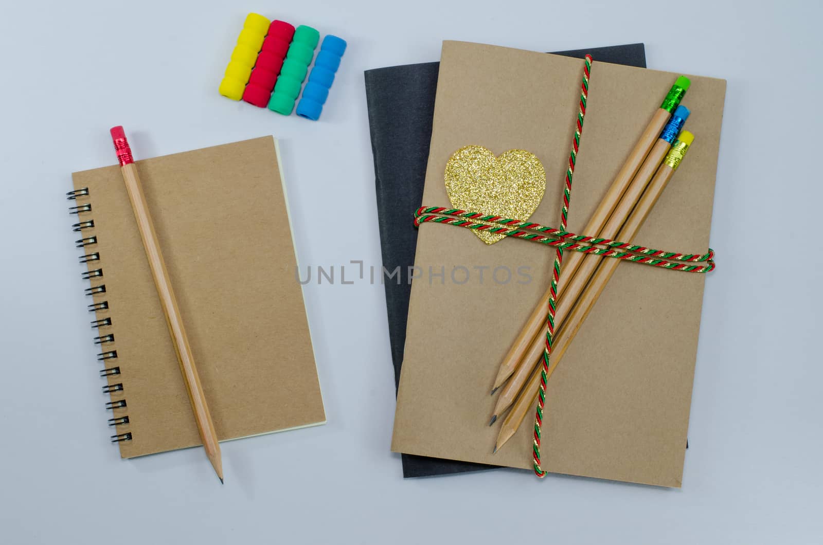 Recycled paper notebook pencils on white background by metal22