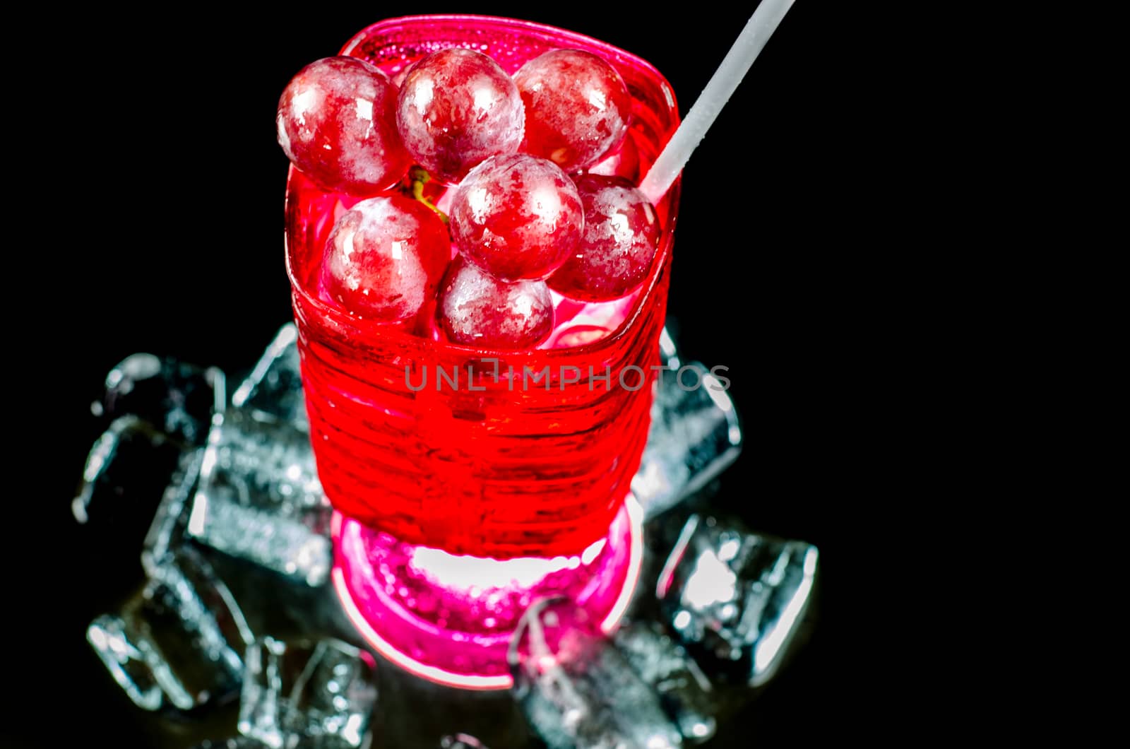 Glasses  red wine and  grape closeup a black background. by metal22