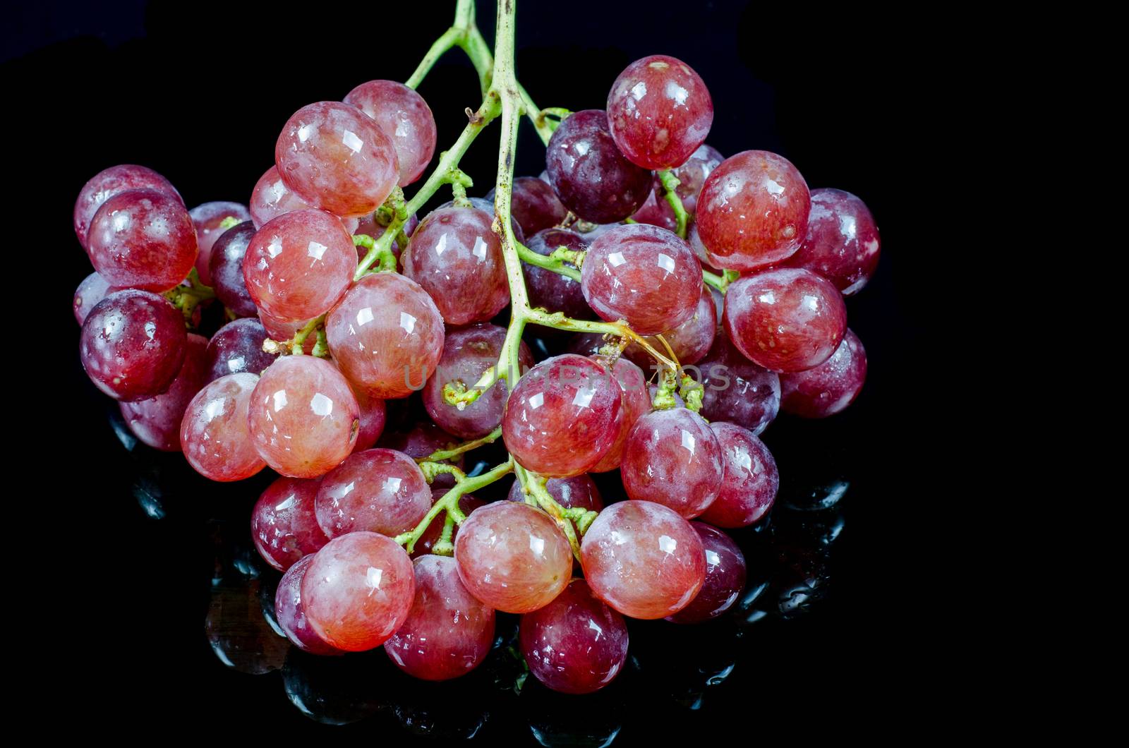 red grape isolated on black by metal22