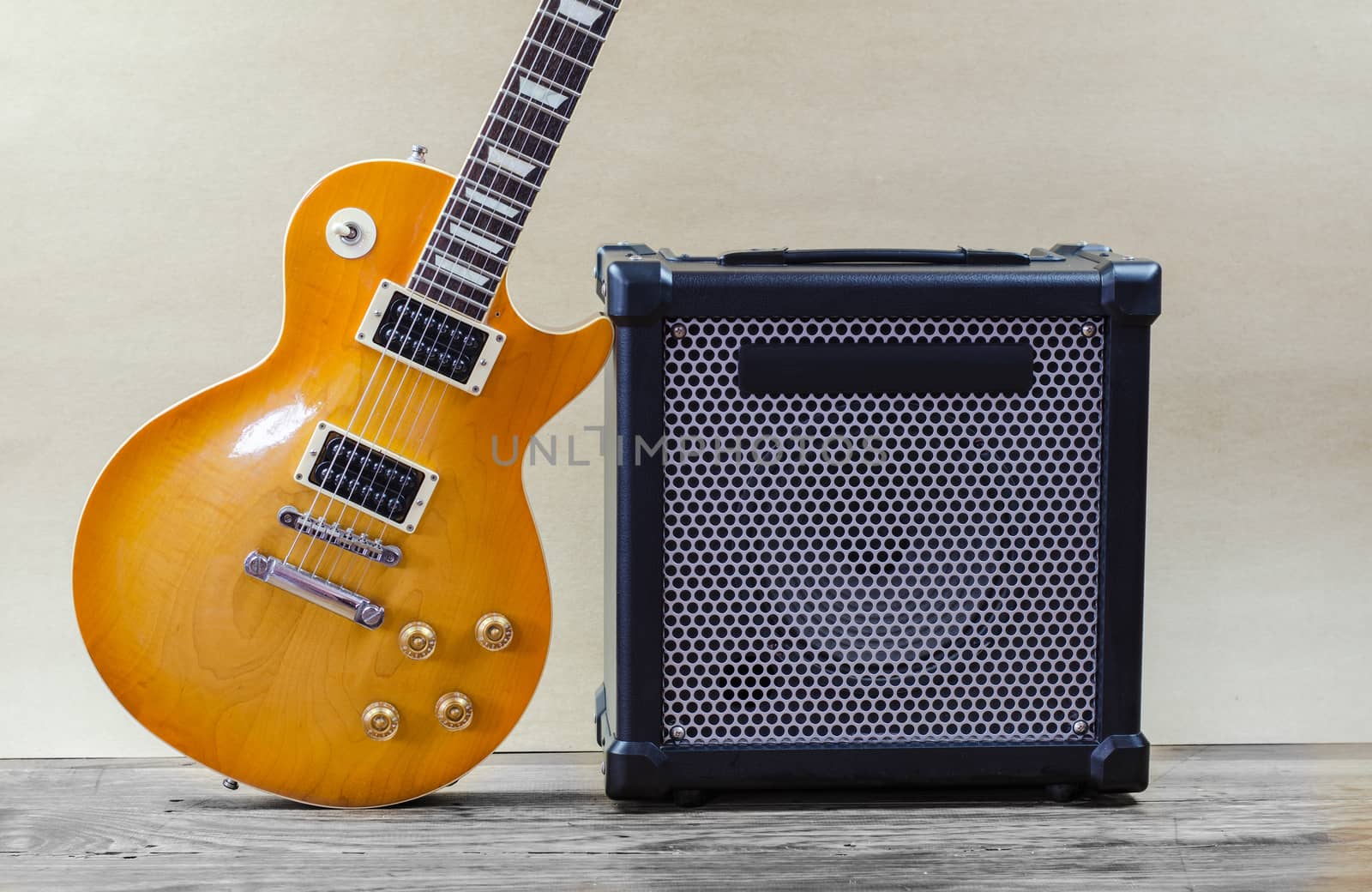 Electric guitar and amplifier isolated on a  light brown by metal22