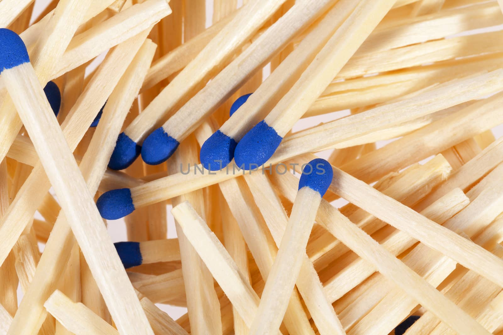 Heap of matches with blue heads isolated on white background by mychadre77