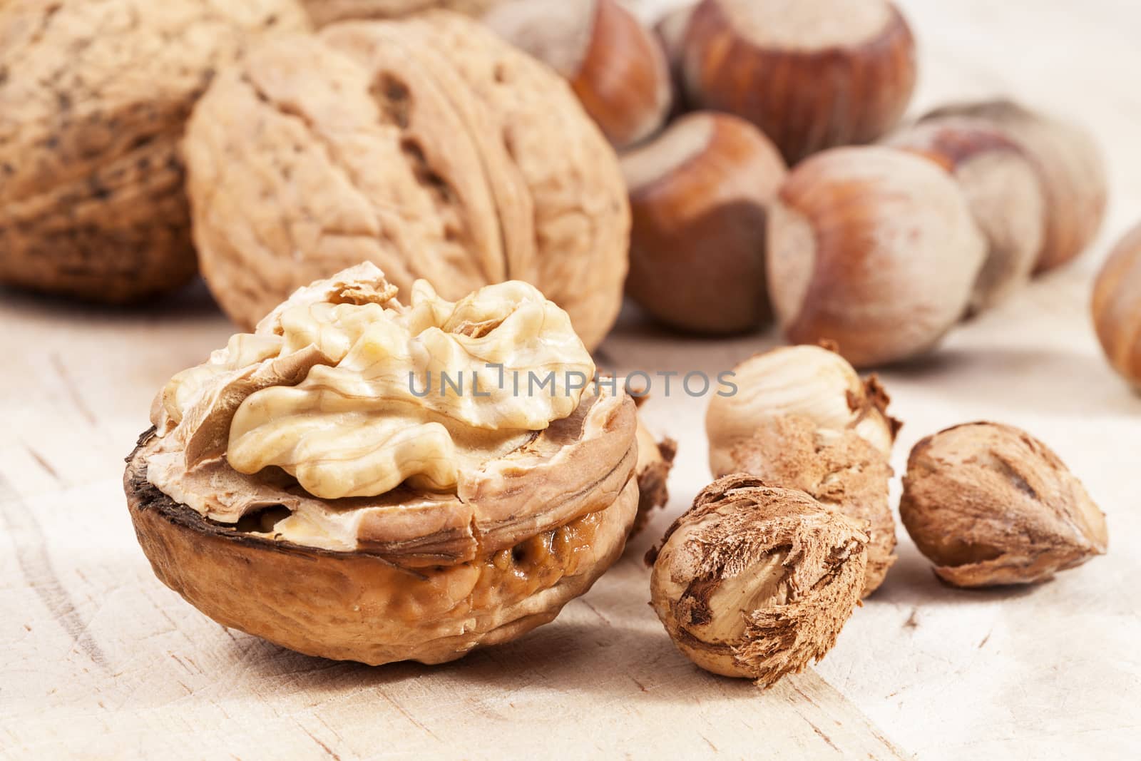 Composition of hazelnuts and walnuts on board, close up by mychadre77