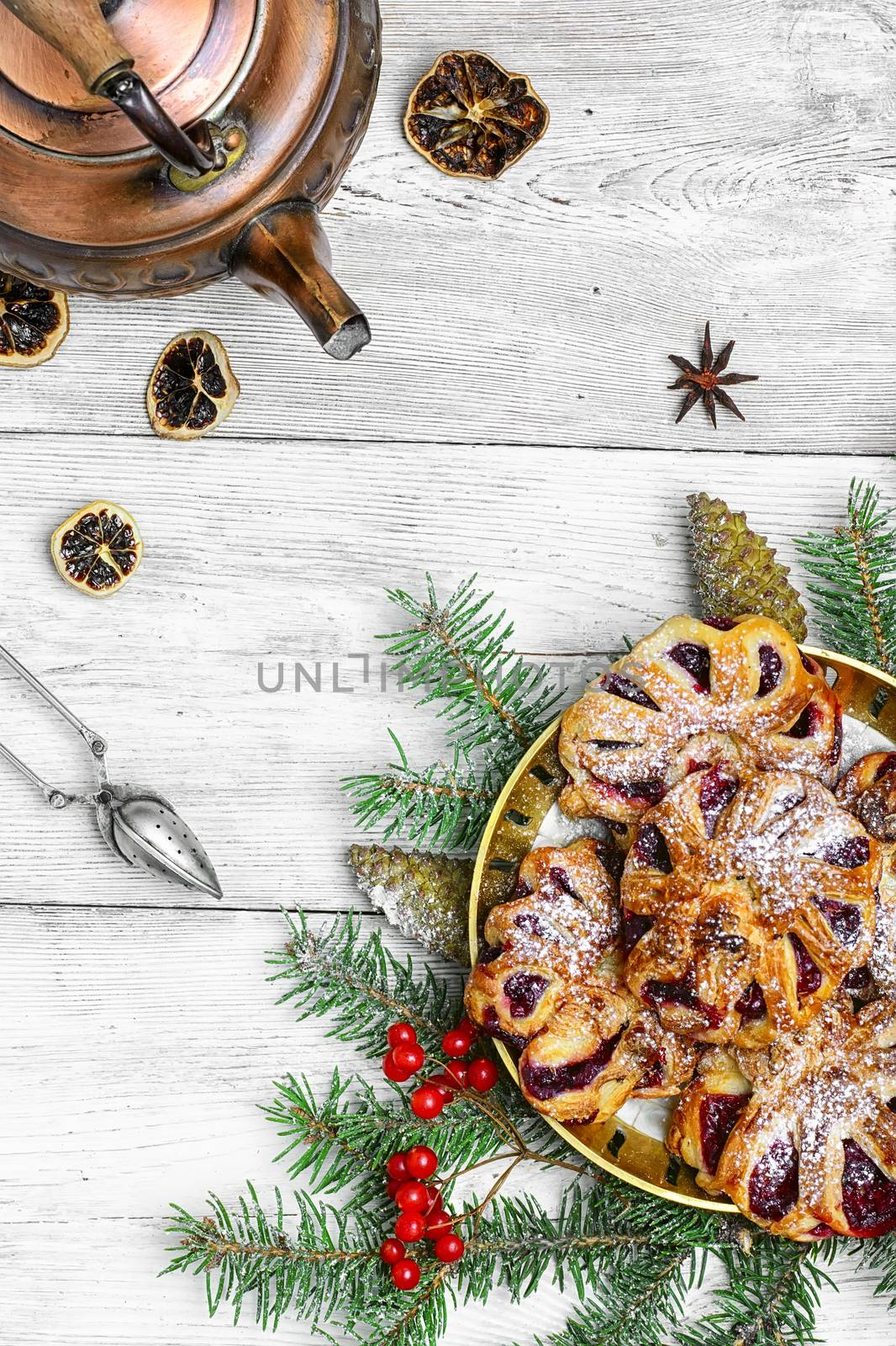 Homemade cookies on plate decorated with fir branches