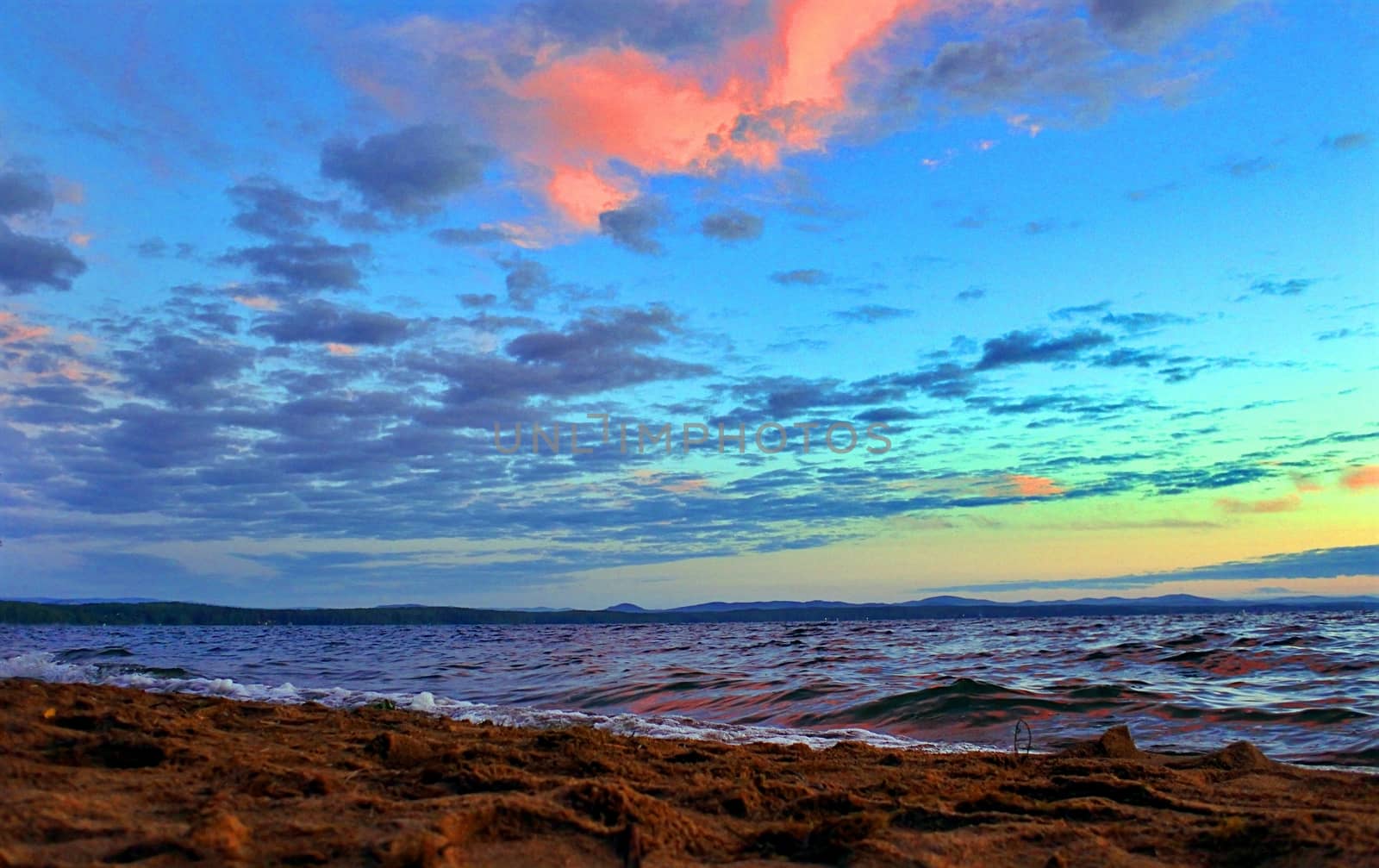 Beautiful sunrise on the lake in windy weather