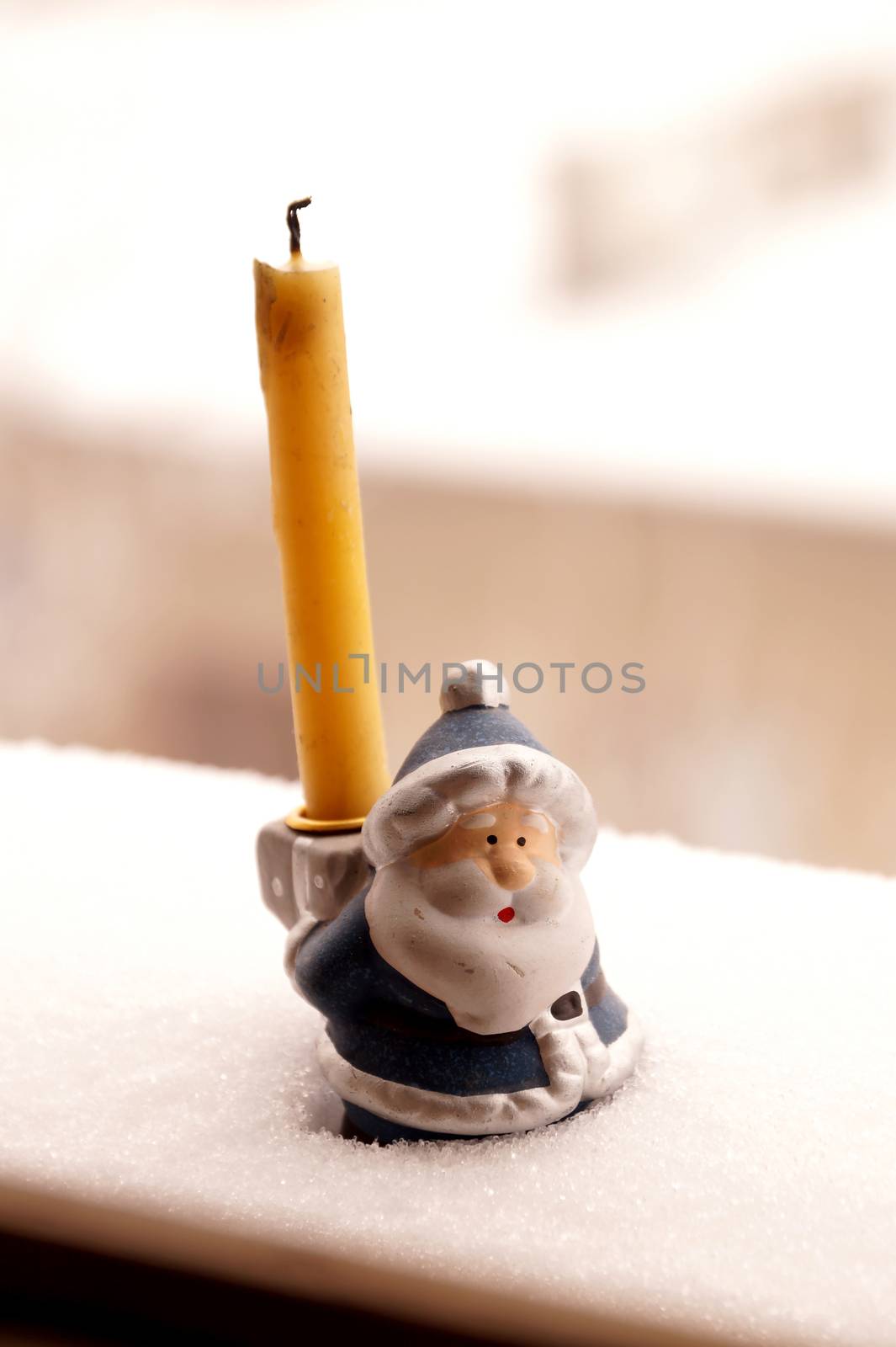 Support under a candle in the form of toy Father Frost