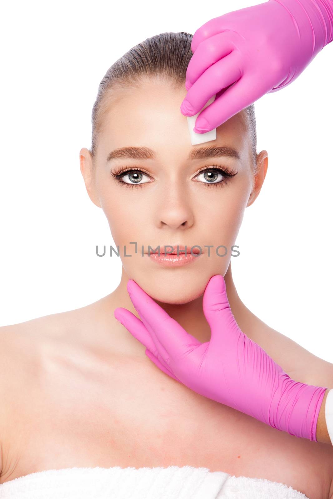 Beautiful face cleansing Cosmetic skincare spa beauty treatment with pink gloves and sponge, on white.