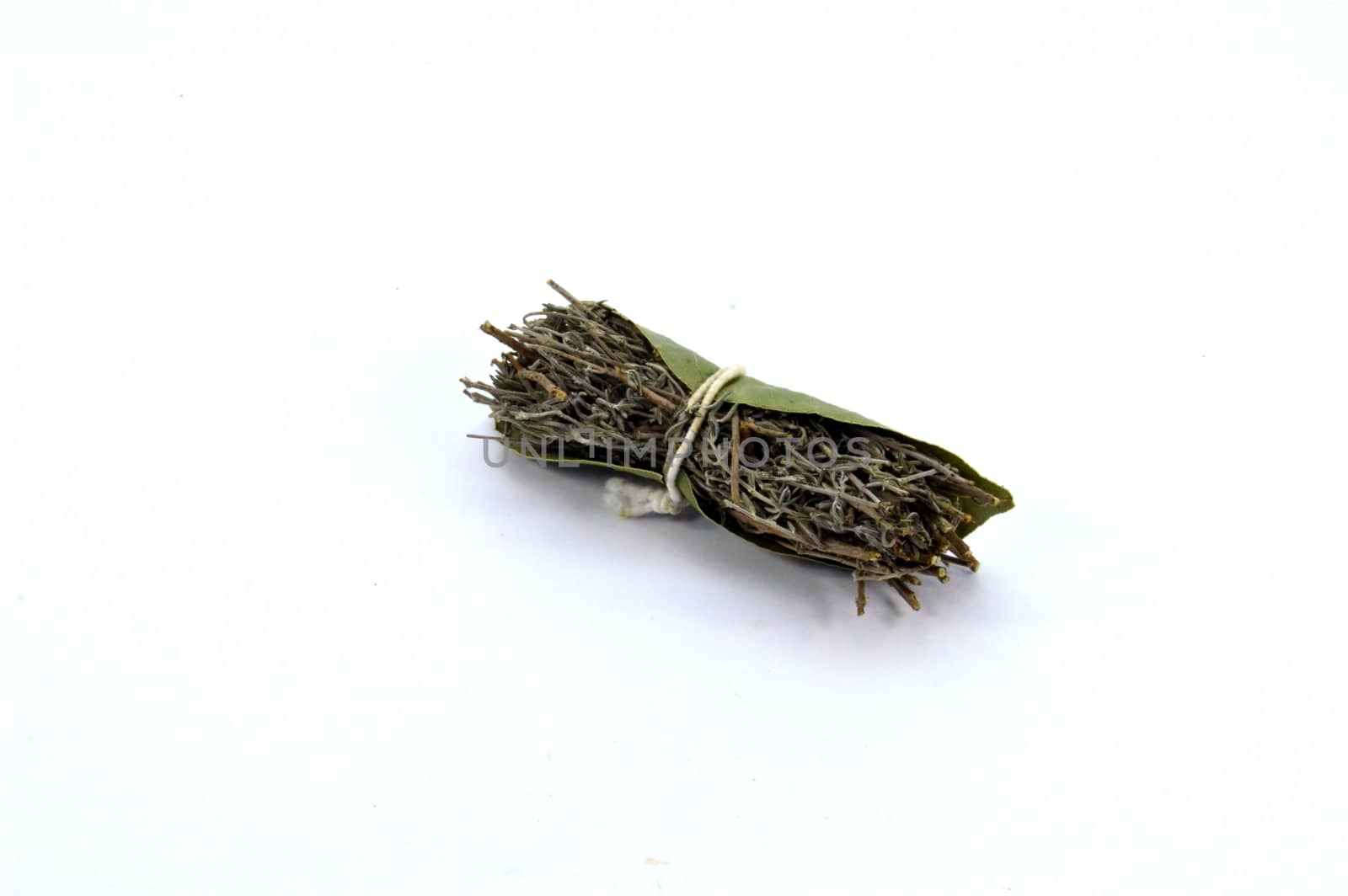 Bouquet garnished for cooking with thyme and bay leaf on white background