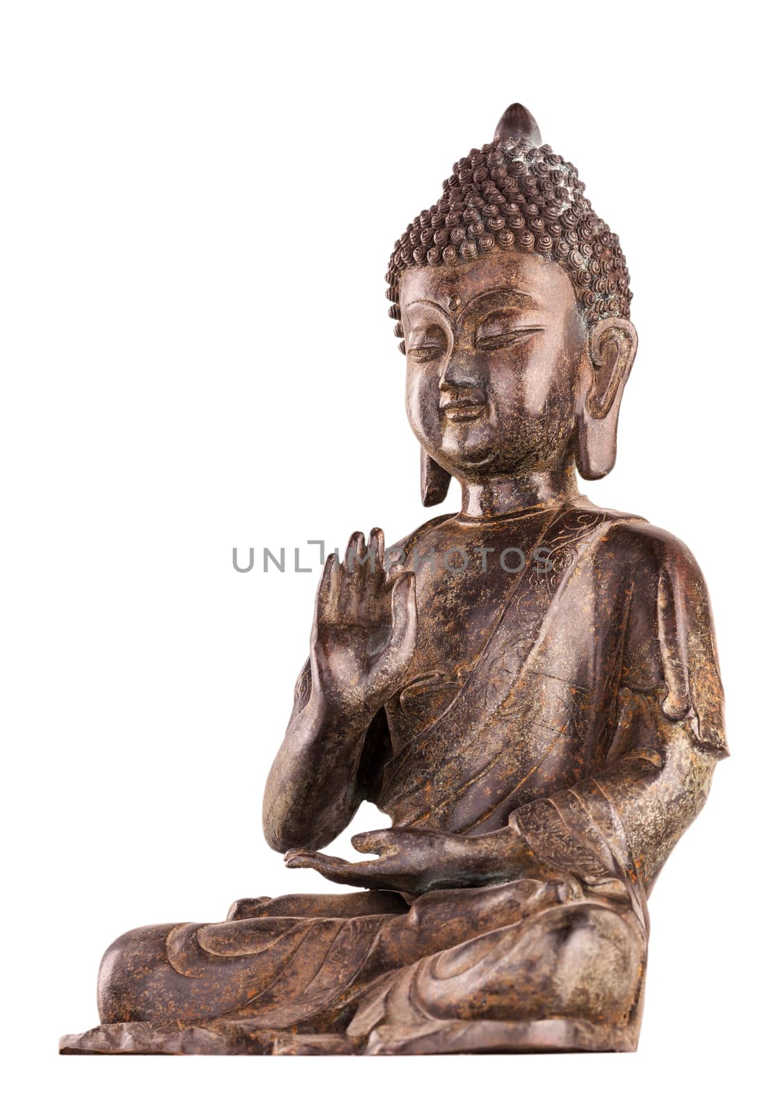 Buddha Shakyamuni's figure in a manual pose - vitarka mudra. The old statue made of metal isolated on a white background.