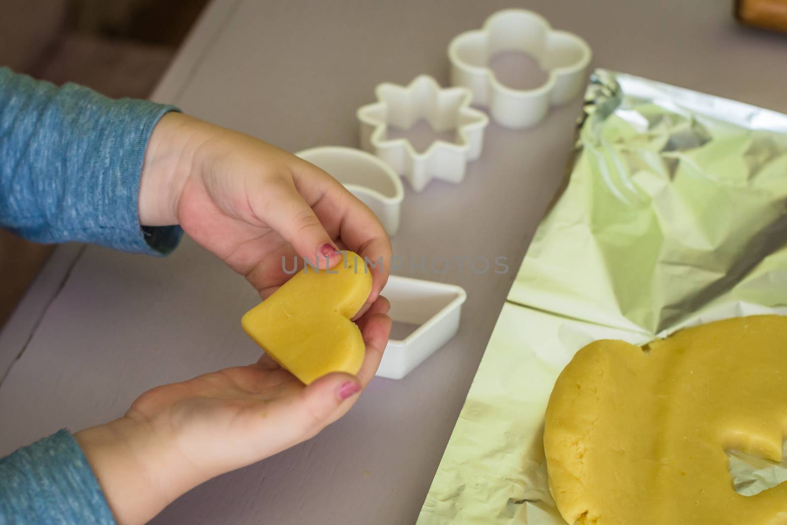 shortcrust dough in the shape of heart for children's hand