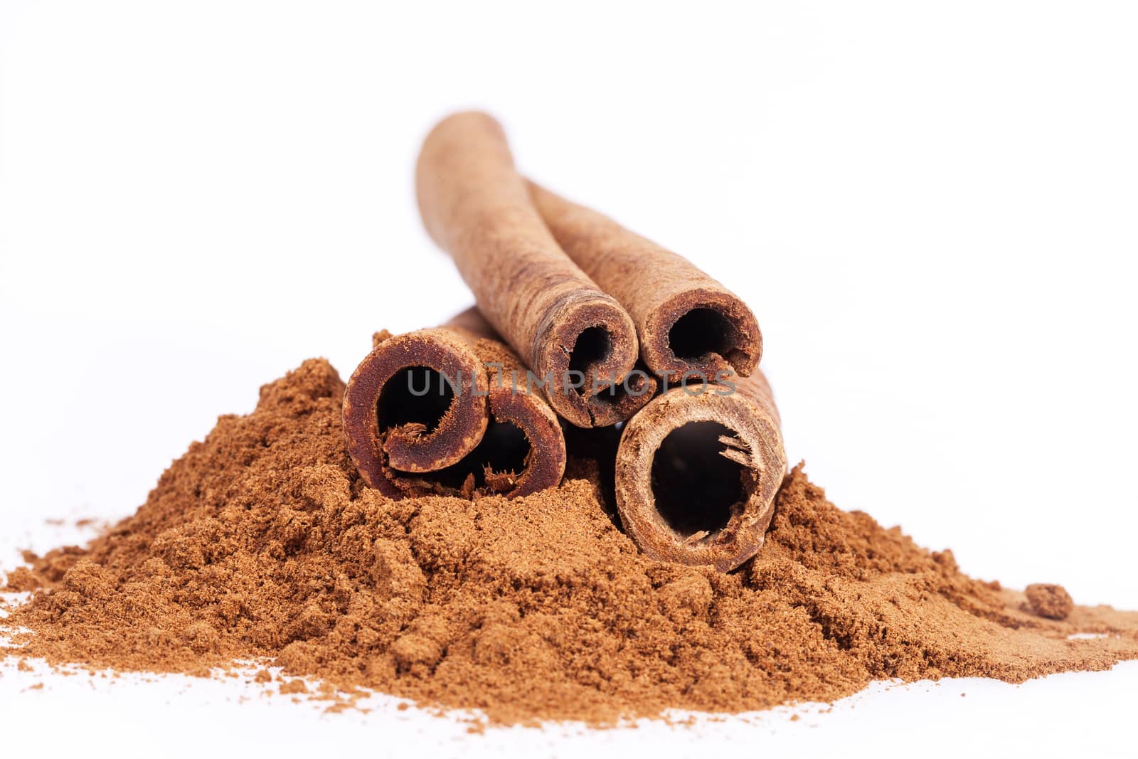 Cinnamon sticks and powder isolated on white background, close up.