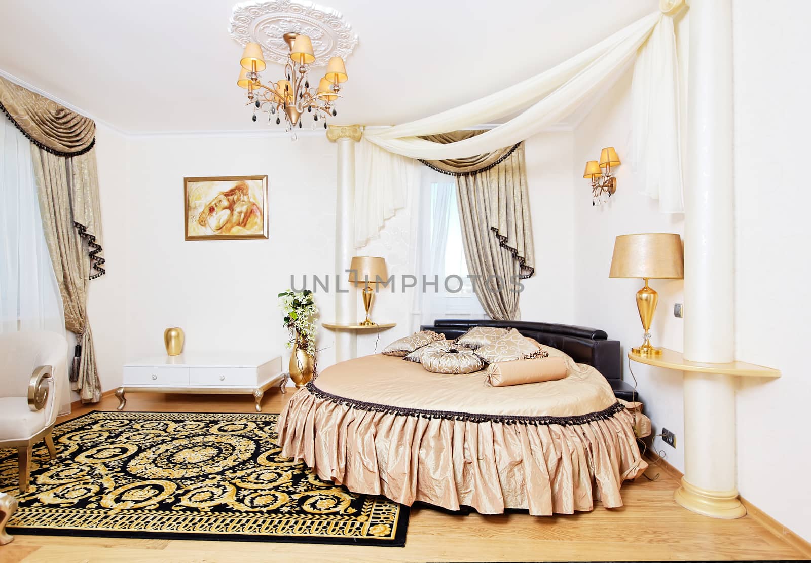 Golden classical bedroom interior with round bed and small table by RawGroup