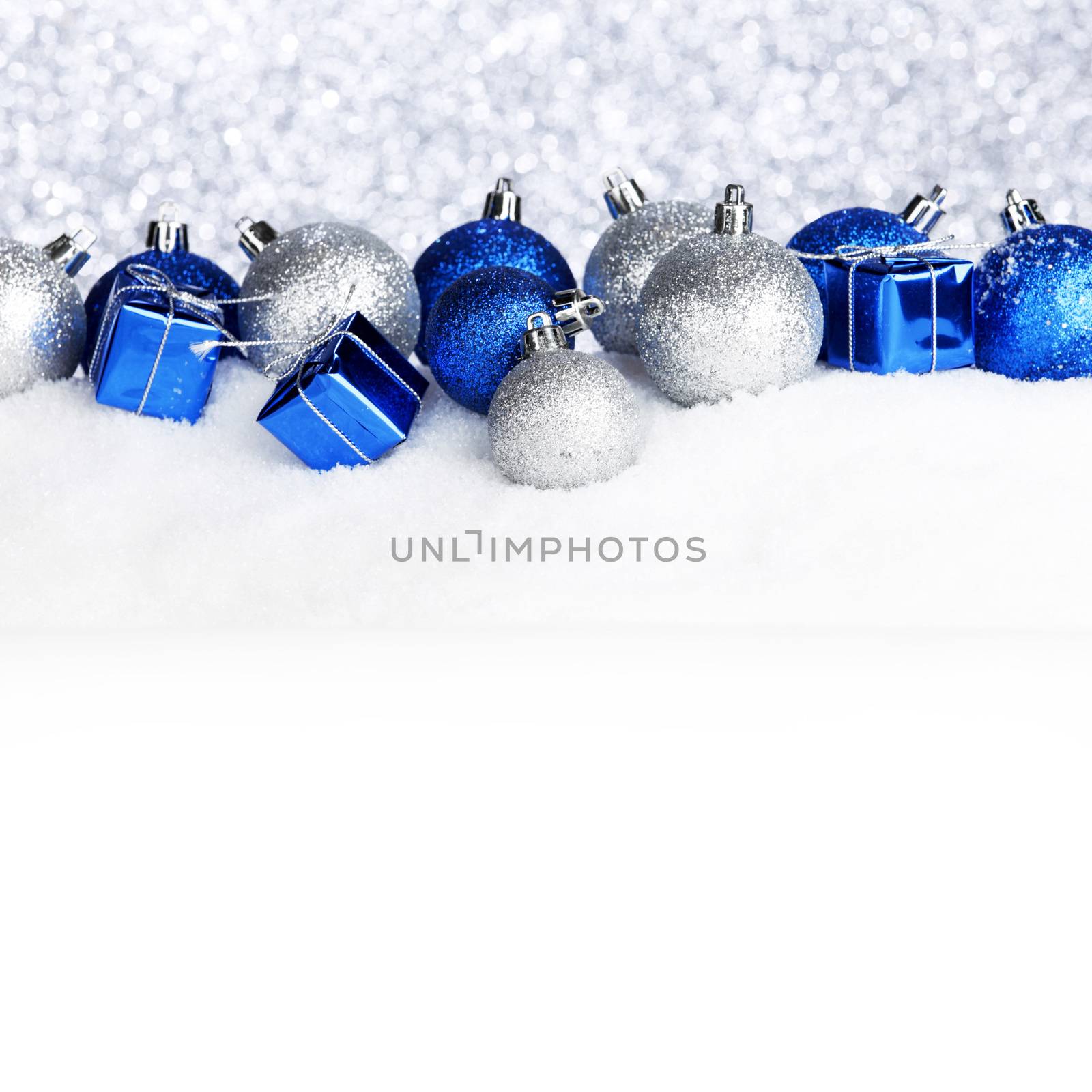 Beautiful various blue and silver christmas decor on snow close-up