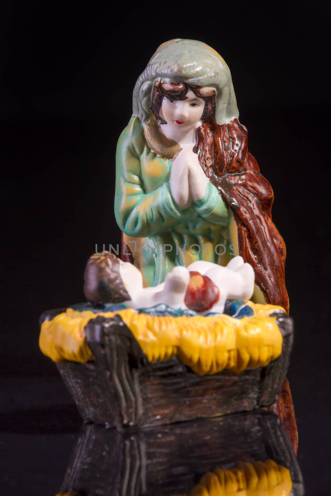 Christmas scene with Jesus and Mary on black background. Focus on Mary!