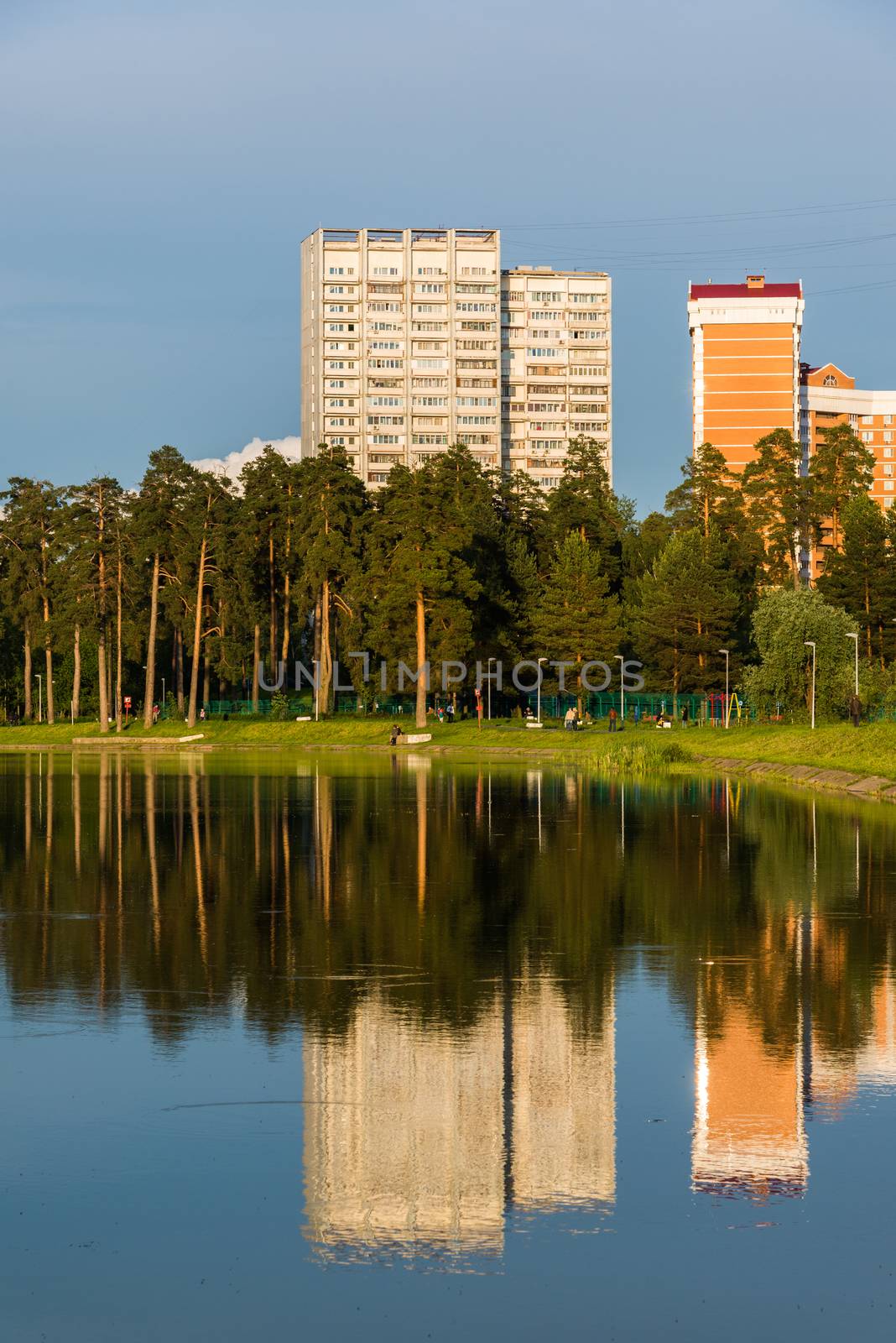 House reflected in lake at sunset light in Zelenograd district of Moscow, Russia by olgavolodina