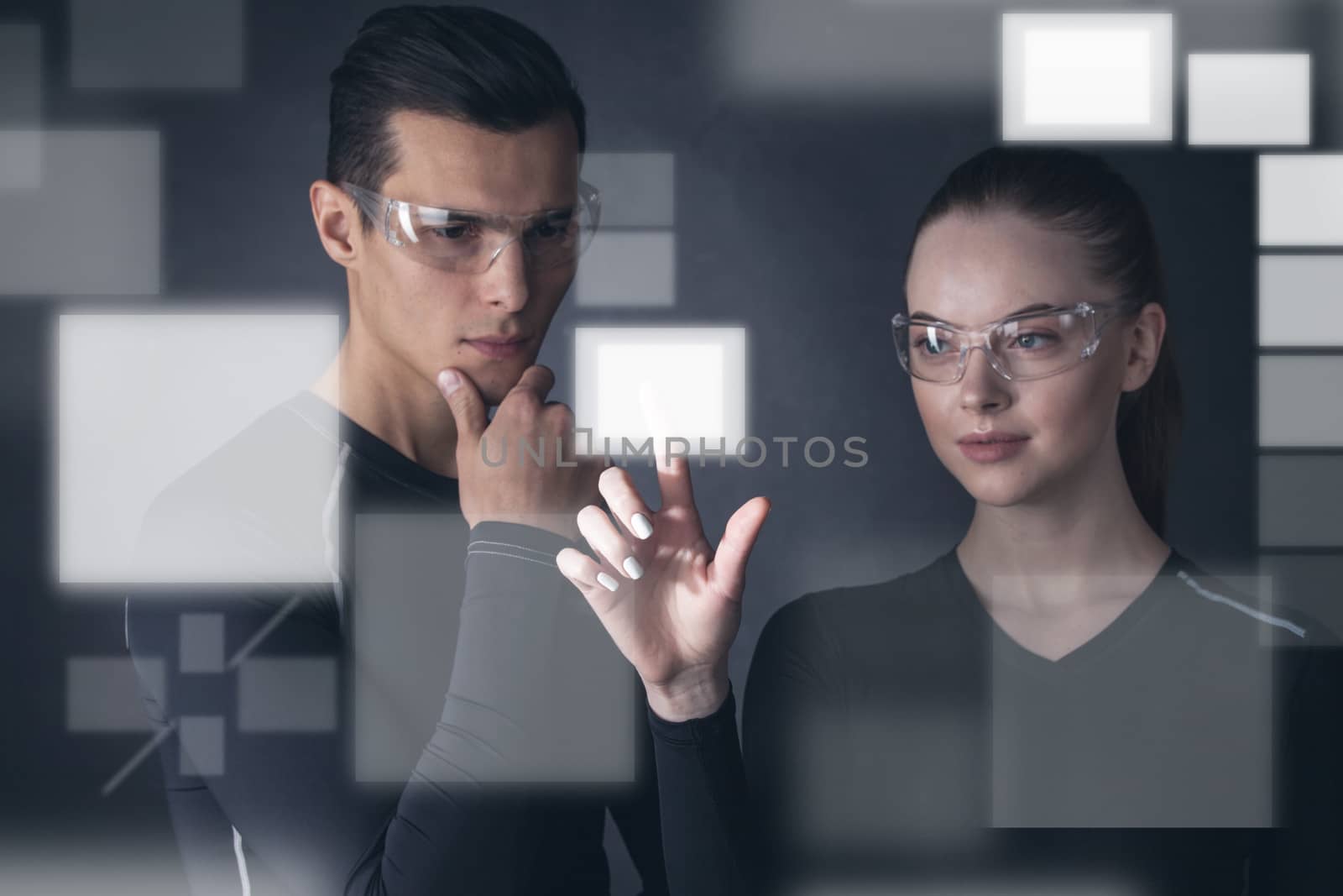 Virtual display concept, man and woman select empty rectangular space