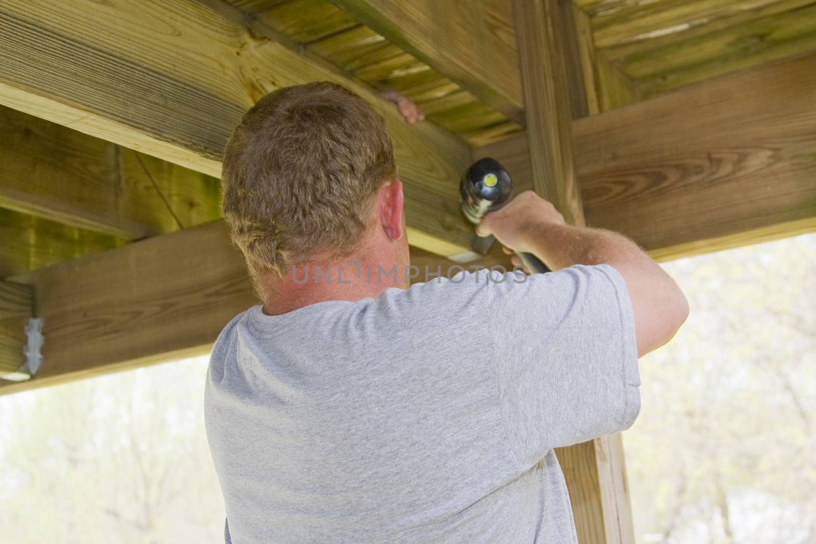 Carpenter securing deck by Trigem