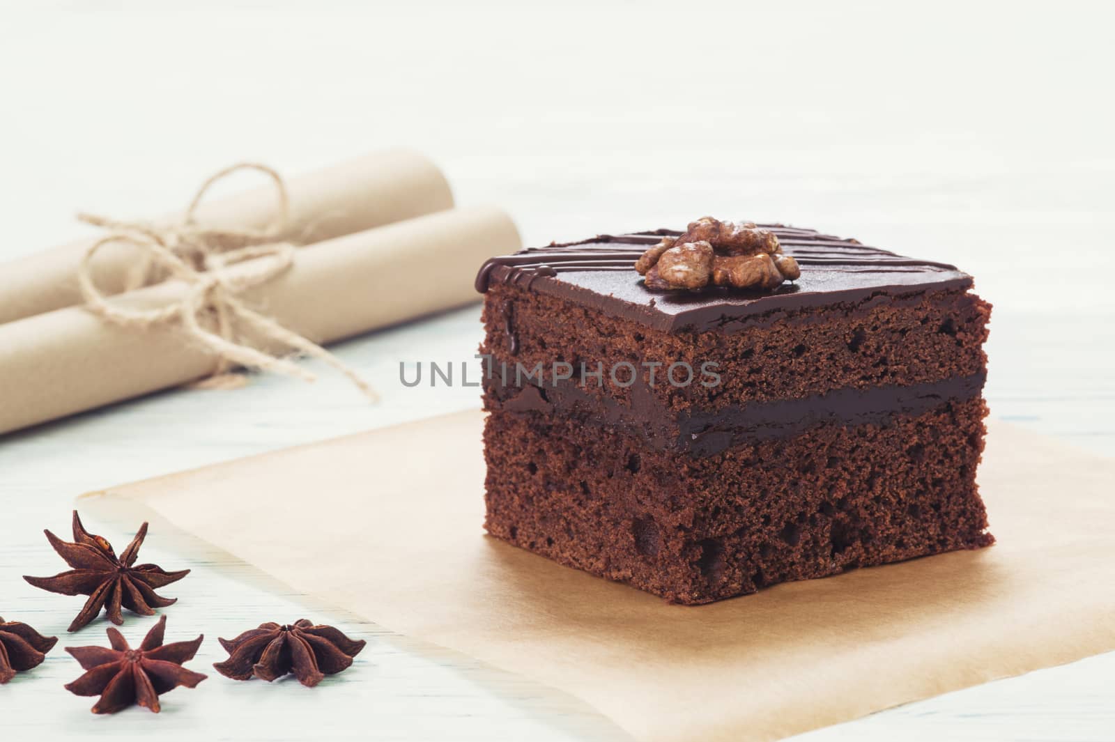 Chocolate cake on baking paper on the light background