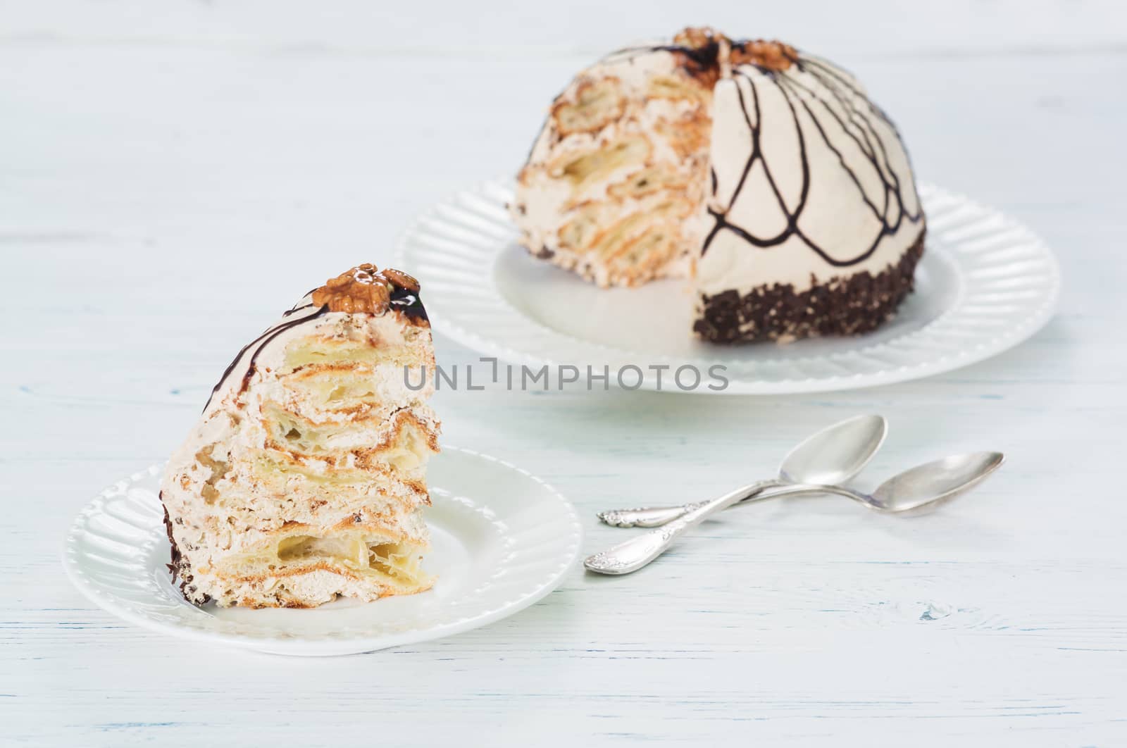 Delicious cake with custard and nuts on light background
