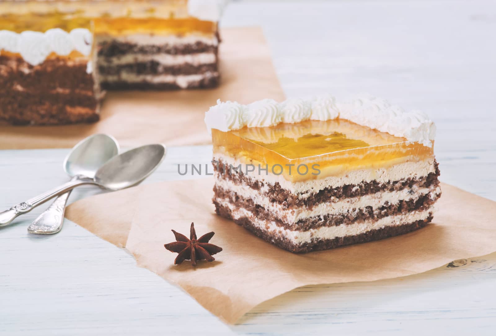 Banana cake with jelly on baking paper on table on light background