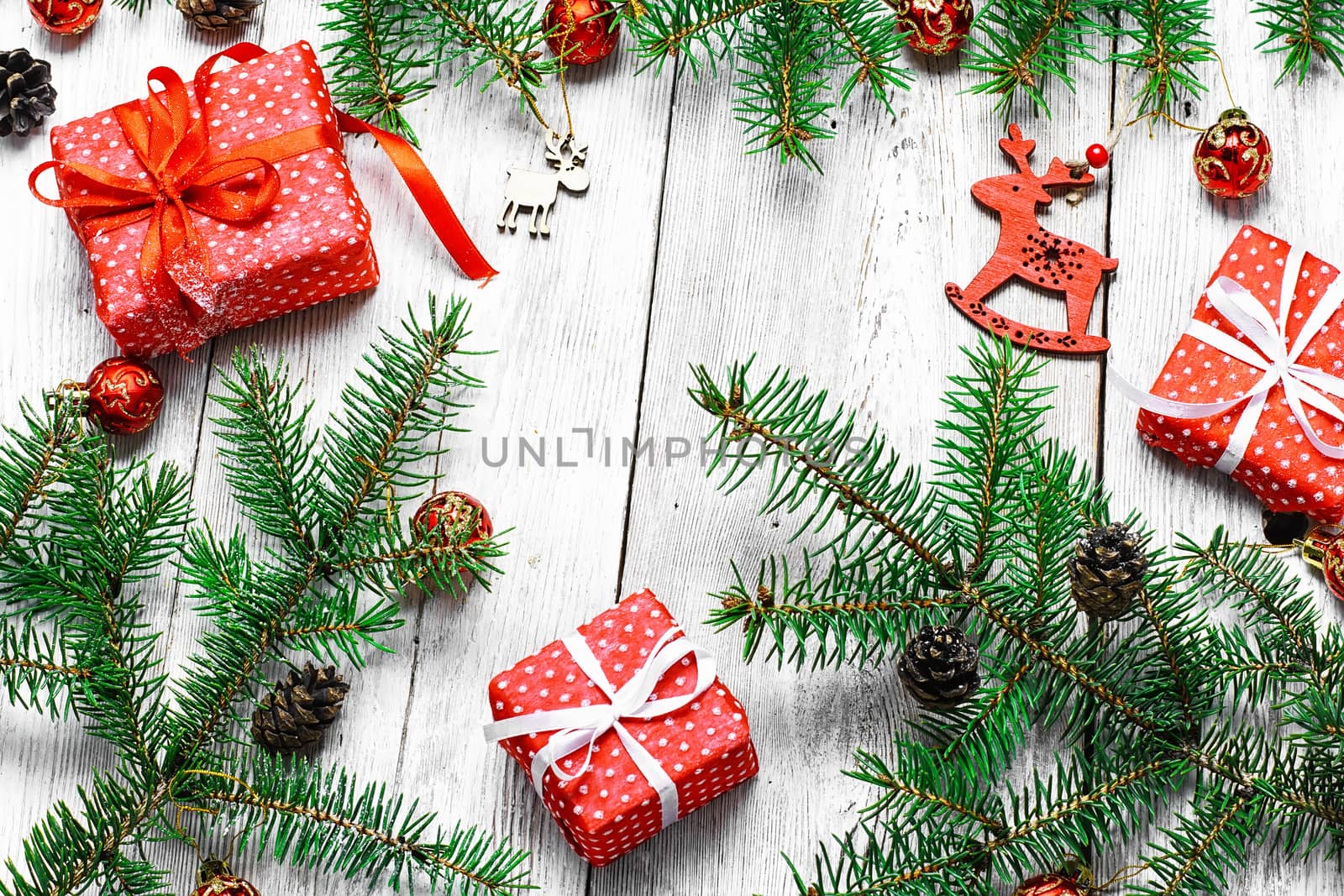 White Christmas background with ornaments,gifts and fir branches