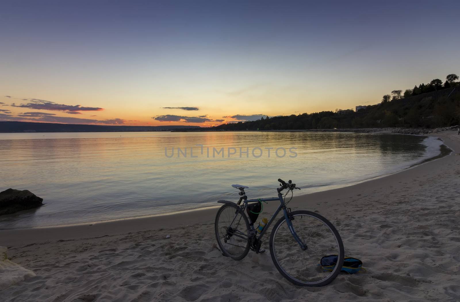 view of bicycle on the shore amid beautiful sunset