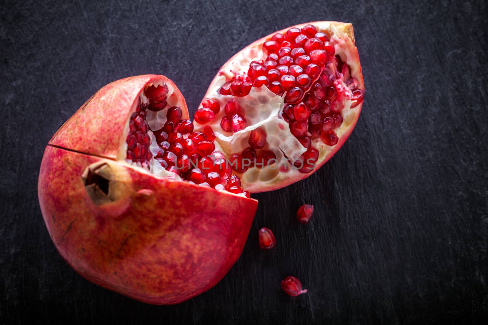 Fresh pomegranate placed on a stone plate