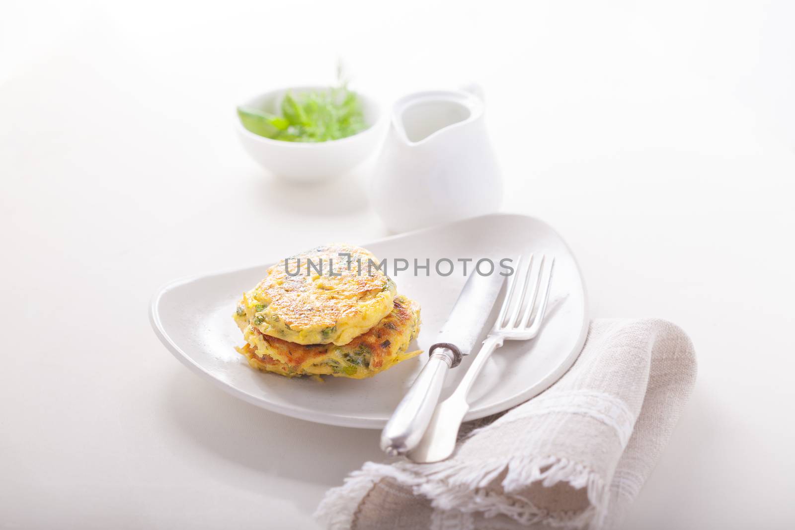 Healthy vegetarian zucchini fritters served on the table