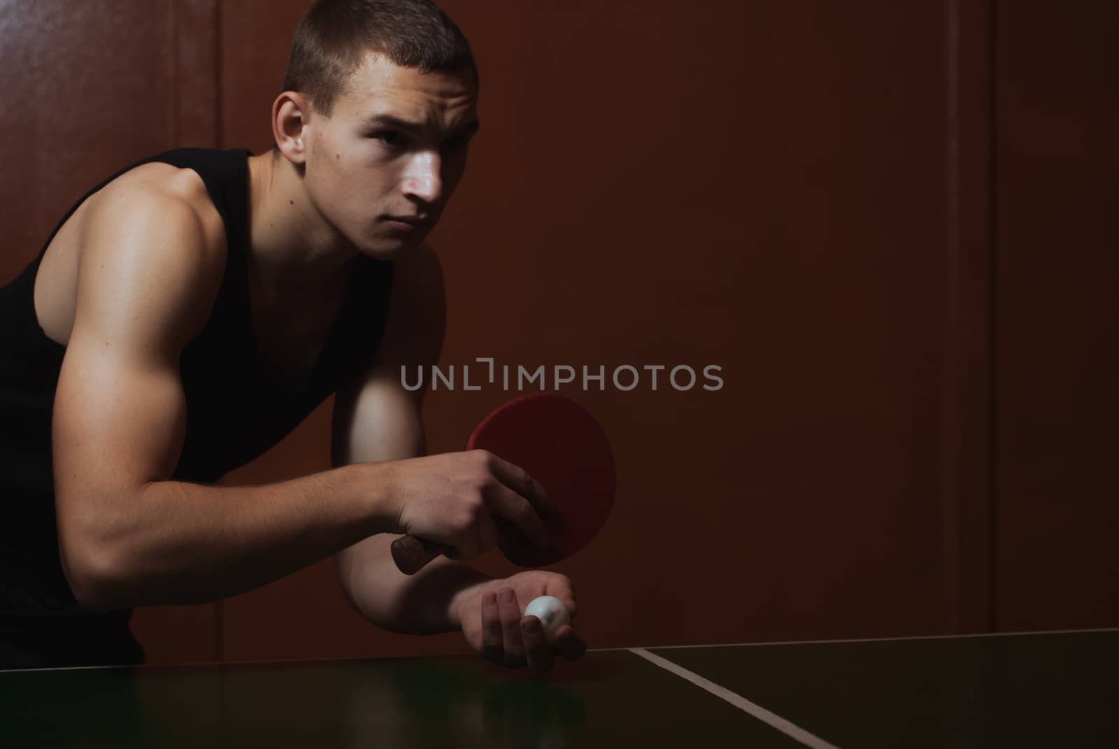 Closeup ping pong, table tennis player, a serious young man in a black shirt, dark atmospheric style