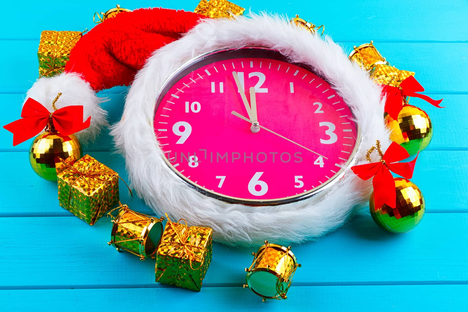 Fir tree with christmas decorations, alarm clock and gift boxes on blue background