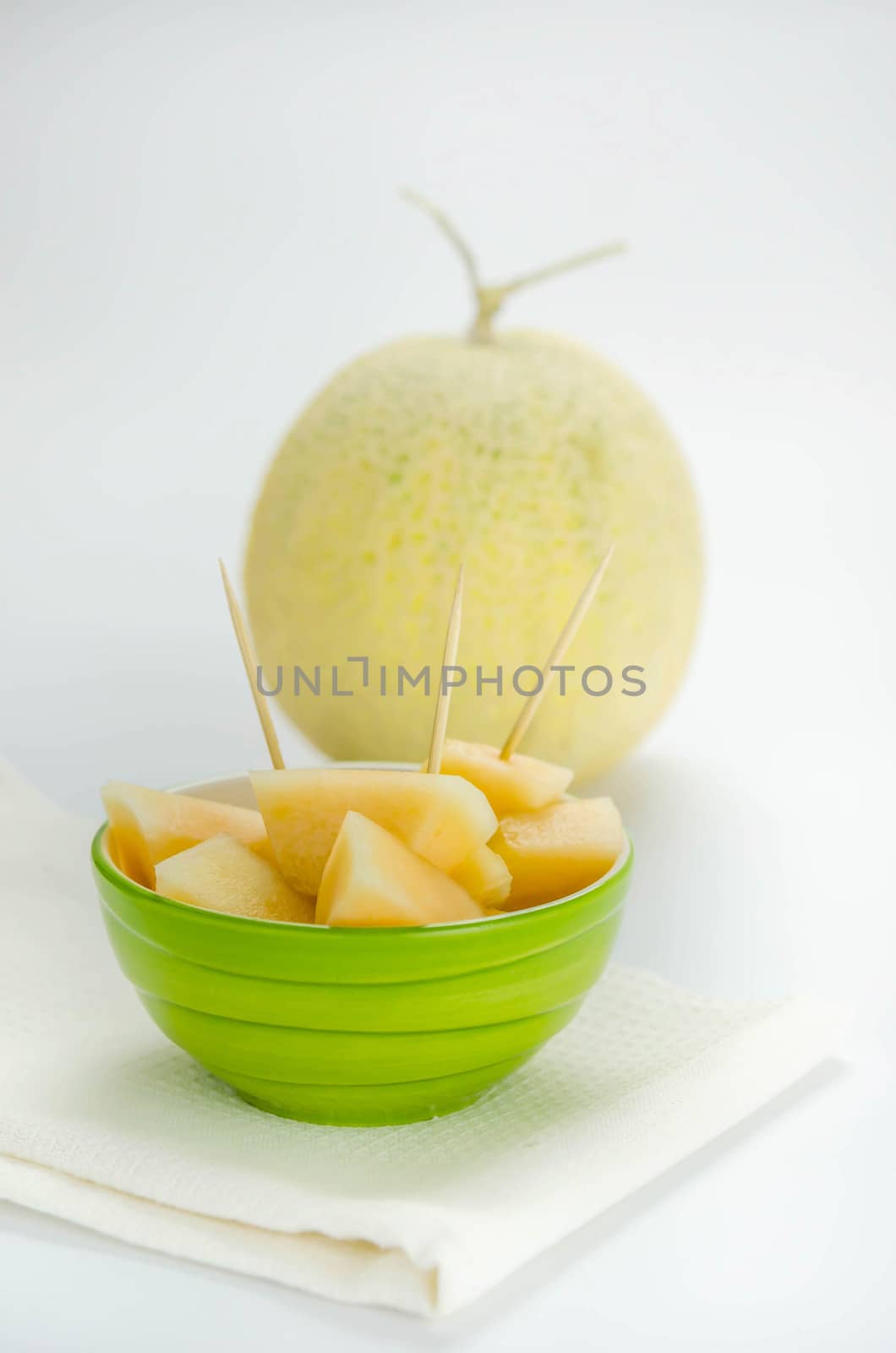 Ripe melon with slice on white background