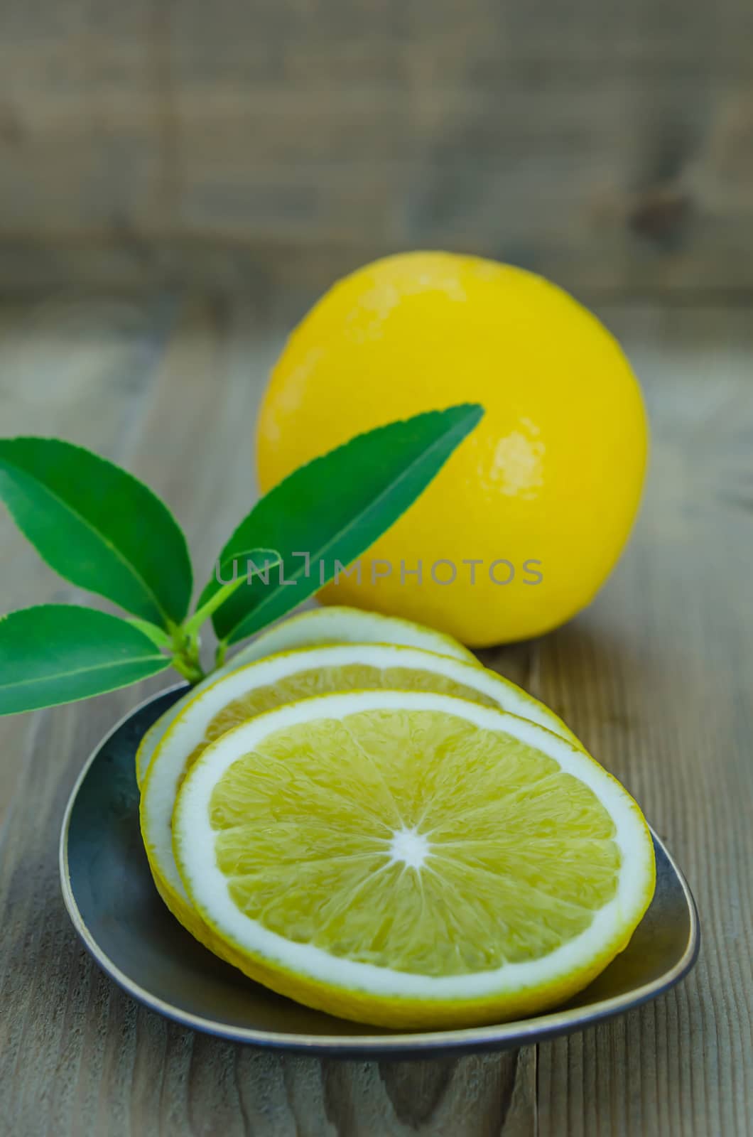 slice orange on dish over wooden background