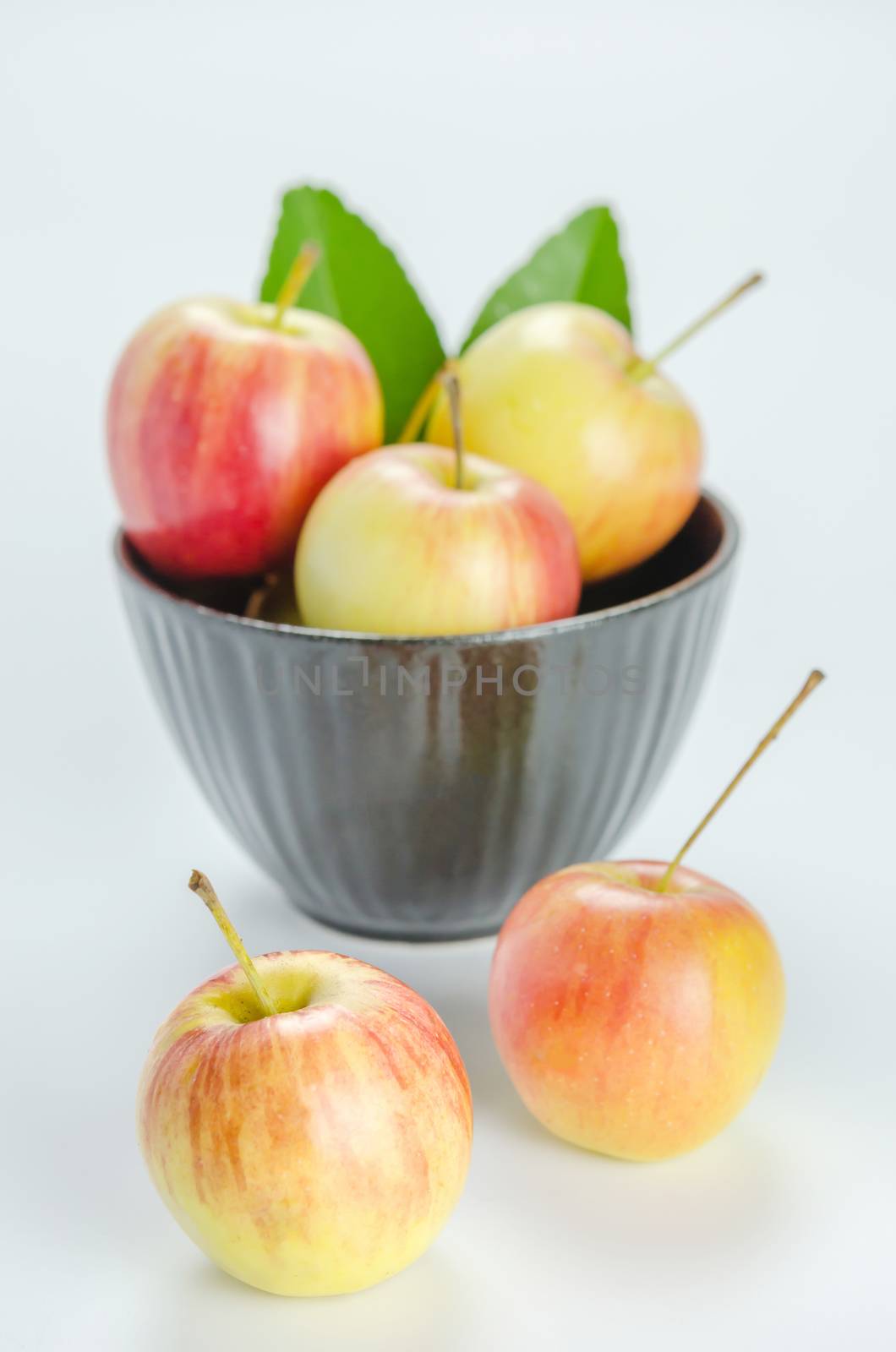 Red and yellow apple with black bowl , organic fresh fruit