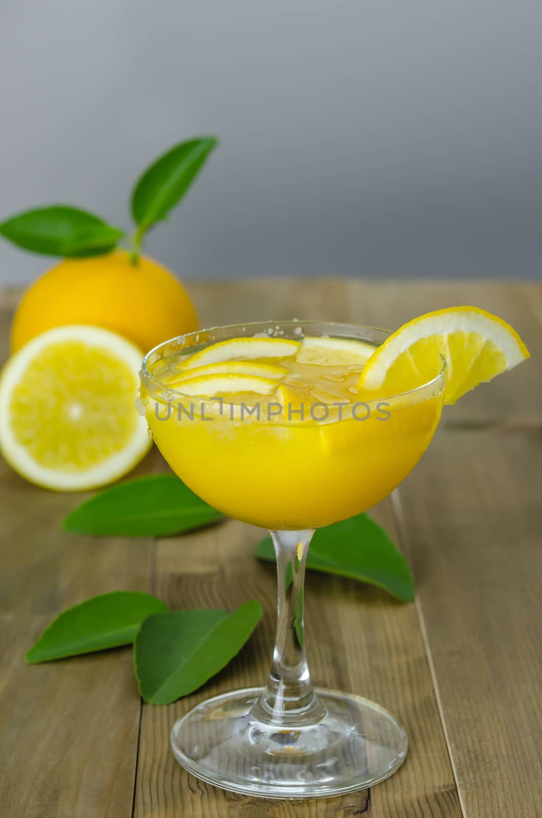Fresh orange juice on wooden table over grunge background