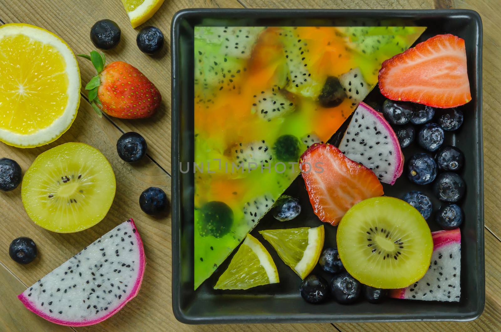 Top view of mixed jelly fruits ( strawberry, blueberry, kiwi, orange, dragon fruit )