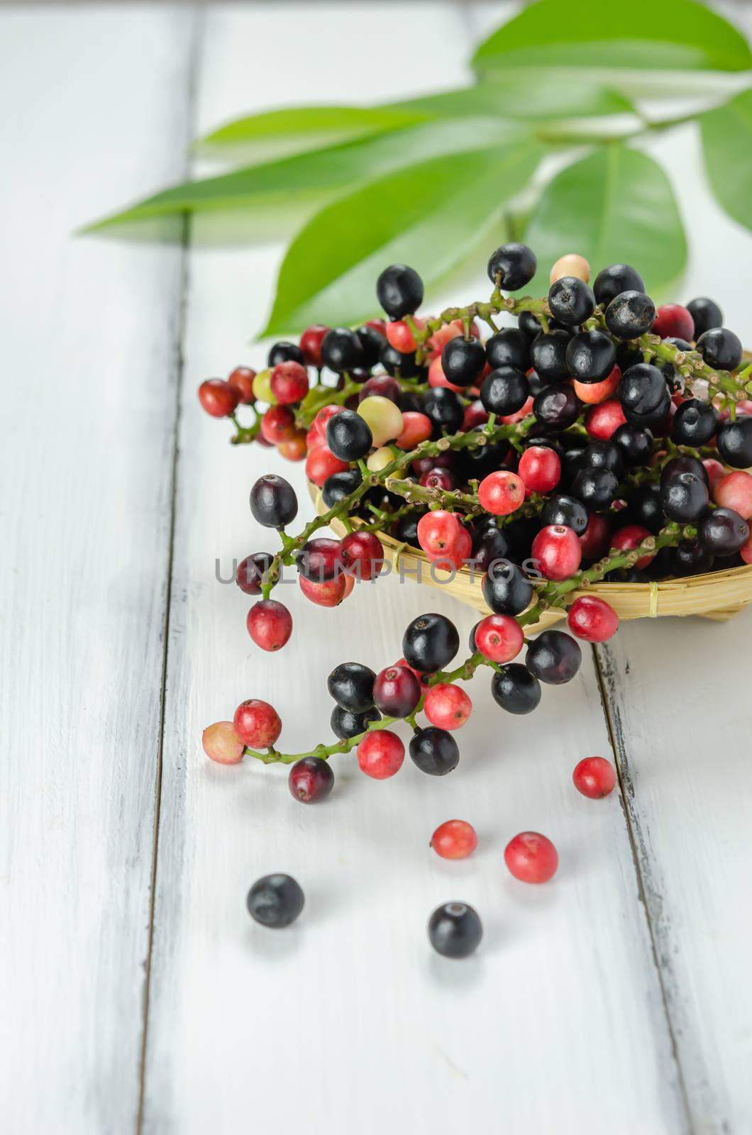 Thai Blueberry in bamboo basket over wooden background
