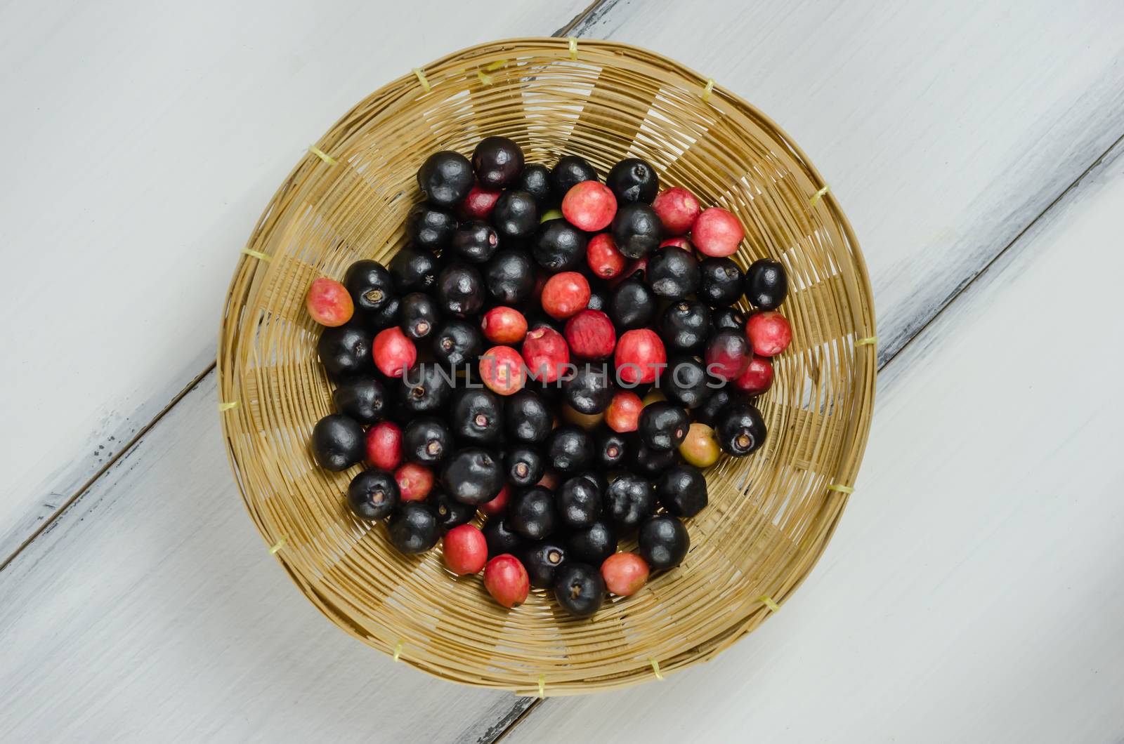 Top view Thai Blueberry in bamboo basket over wooden background