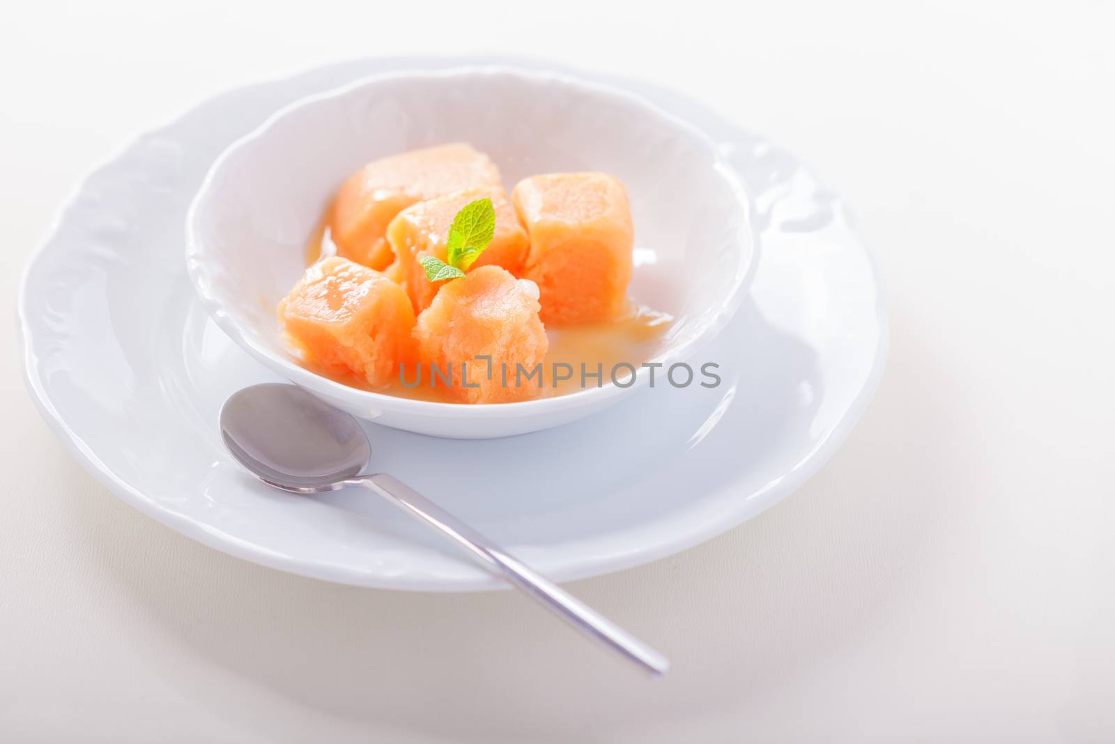 Apricot sorbet with mint served on the table
