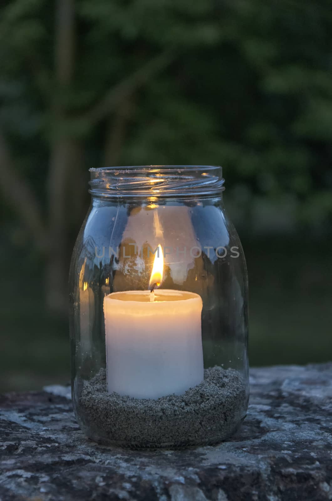 Glass jar with lit candle inside by sephirot17