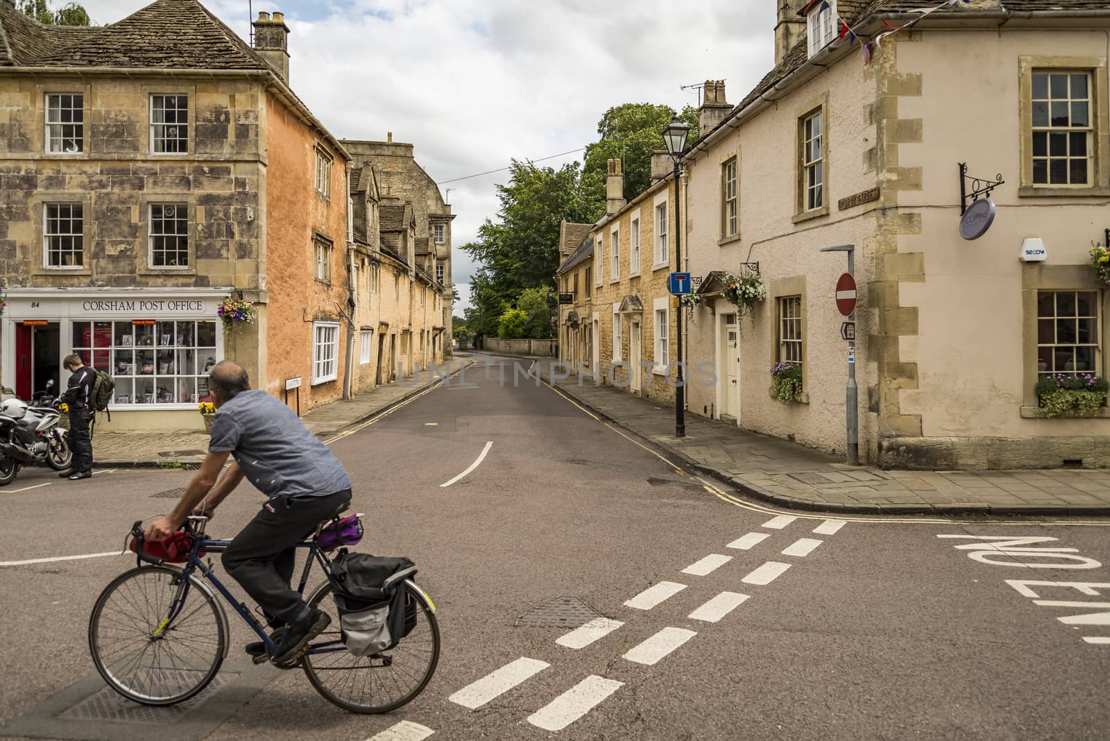 CORSHAM, UK: a person rides his bike in a street in Corsham, an old village in south of England on July, 17, 2015 in Corsham, UK