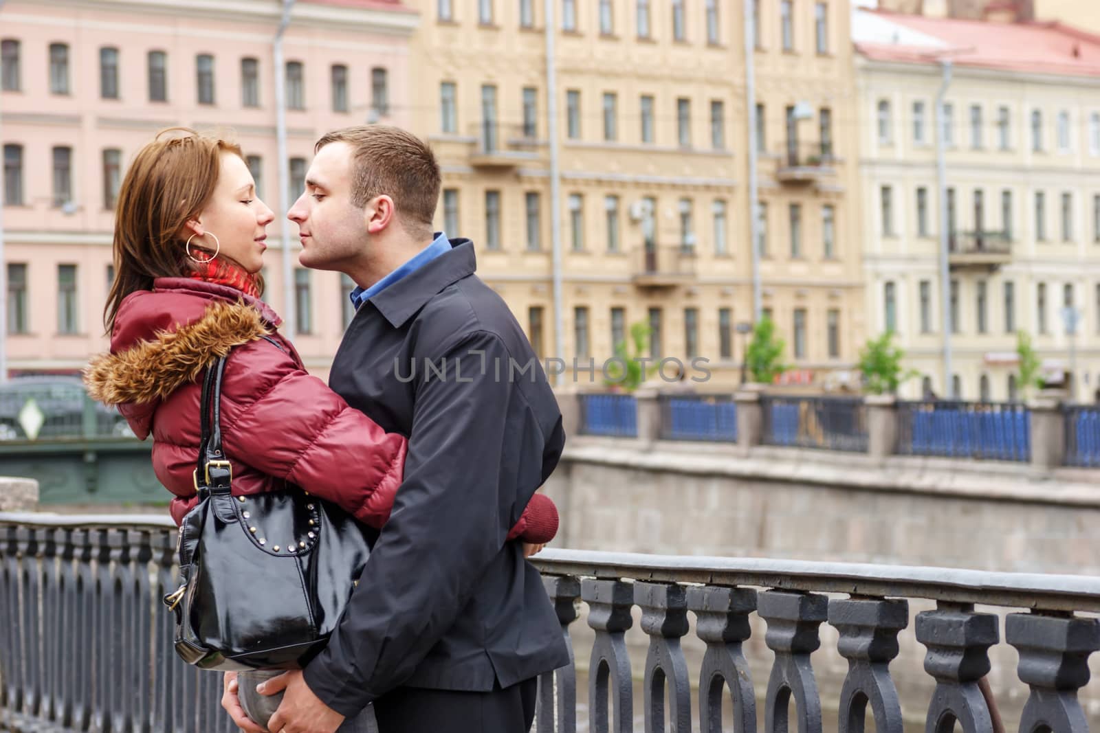 Happy young couple embracing while city walking