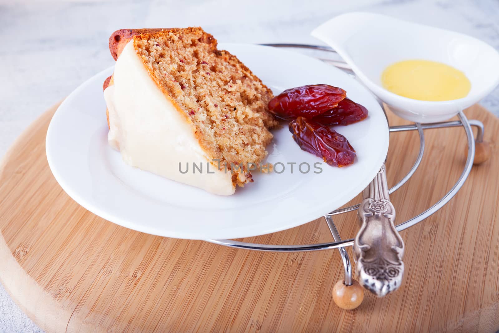 Slice of date cake on a white plate by supercat67