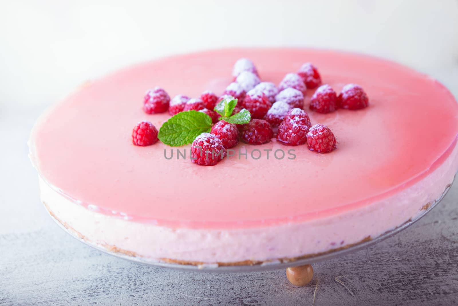 Raspberry yogurt cake with berries on the top.