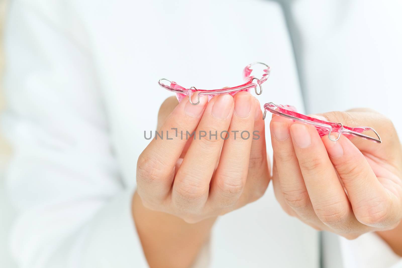 Dentist holding Retainer, Orthodontics Dental concept background