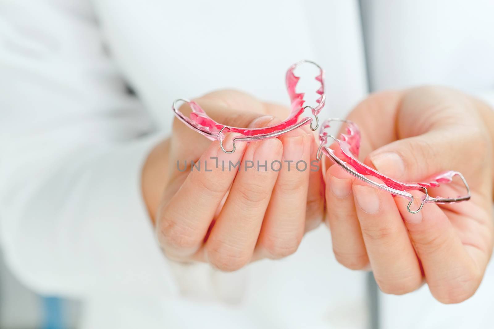 Dentist holding Retainer, Orthodontics Dental concept background