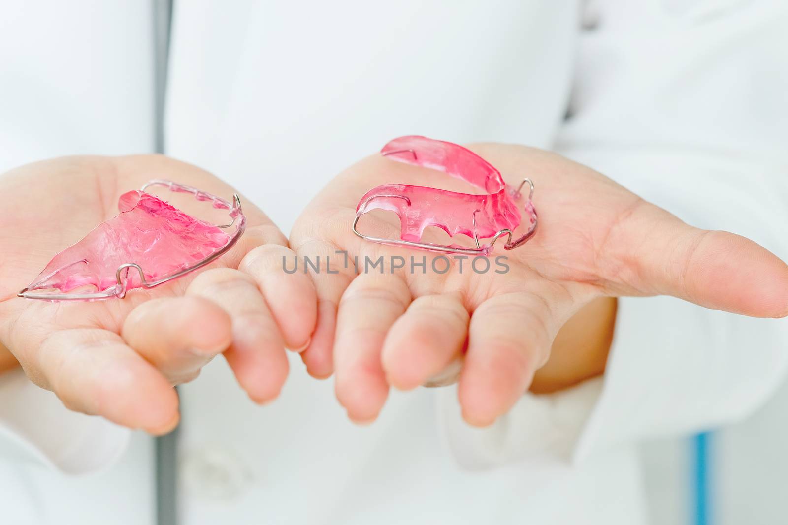 Dentist holding Retainer, Orthodontics Dental concept background