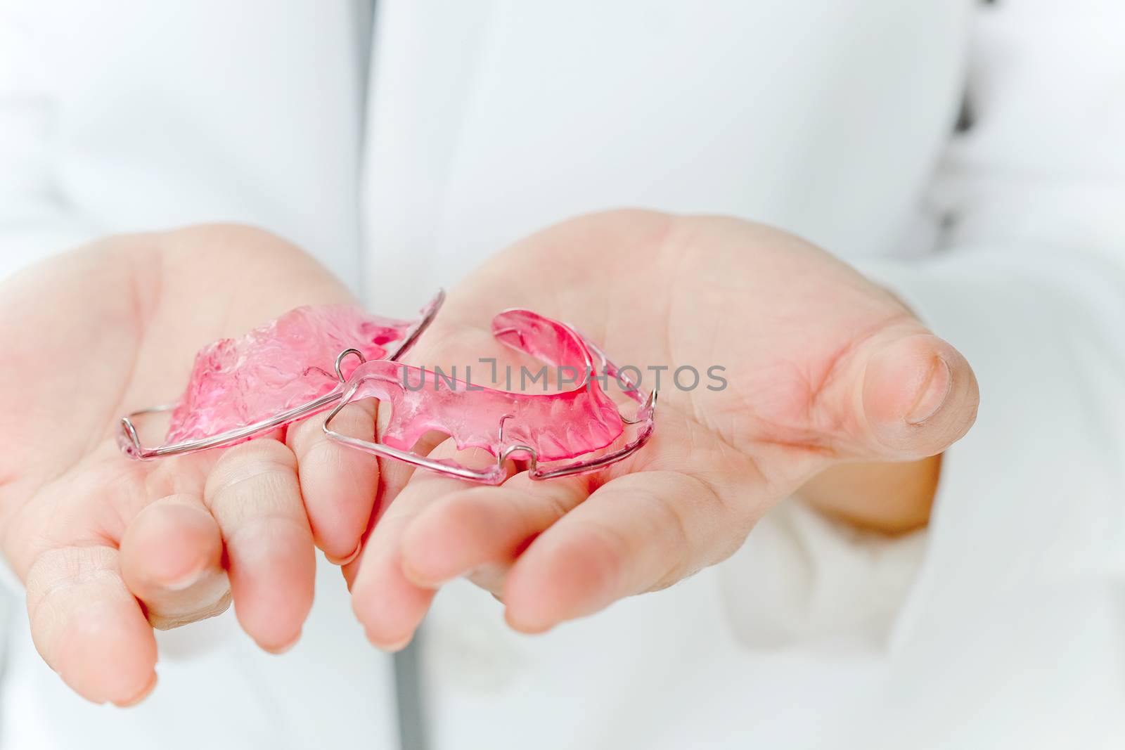 Dentist holding Retainer, Orthodontics Dental concept background