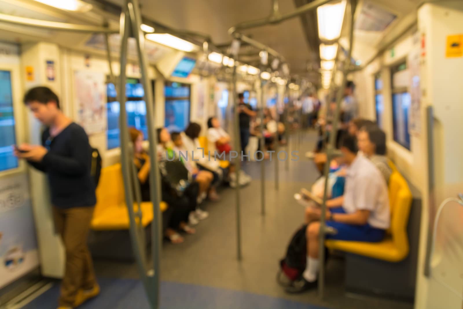 People Sitting on Mass Transit (Sky Train or Subway), Abstract Blur Defocus Background.