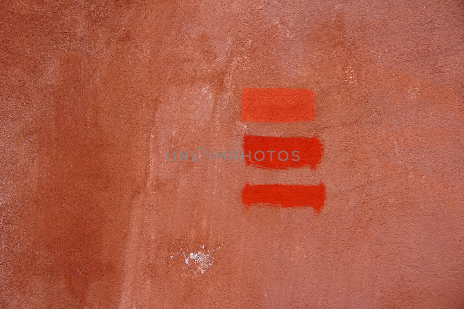 Three lines of red brick colour, painted on concrete wall